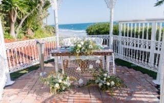 A scenic gazebo with beautiful flowers and an ocean view, perfect for Southern California wedding venues.