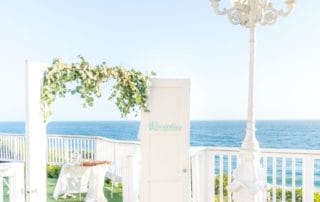 A breathtaking wedding ceremony set up on a balcony overlooking the ocean, perfect for couples seeking picturesque Southern California wedding venues or dreamy wedding venues in Laguna Beach.