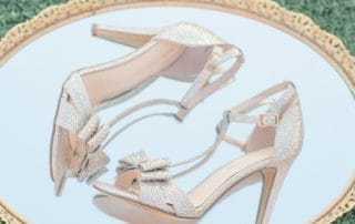 A pair of high heeled shoes on a gold plate at a glamorous Southern California wedding venue in Laguna Beach.
