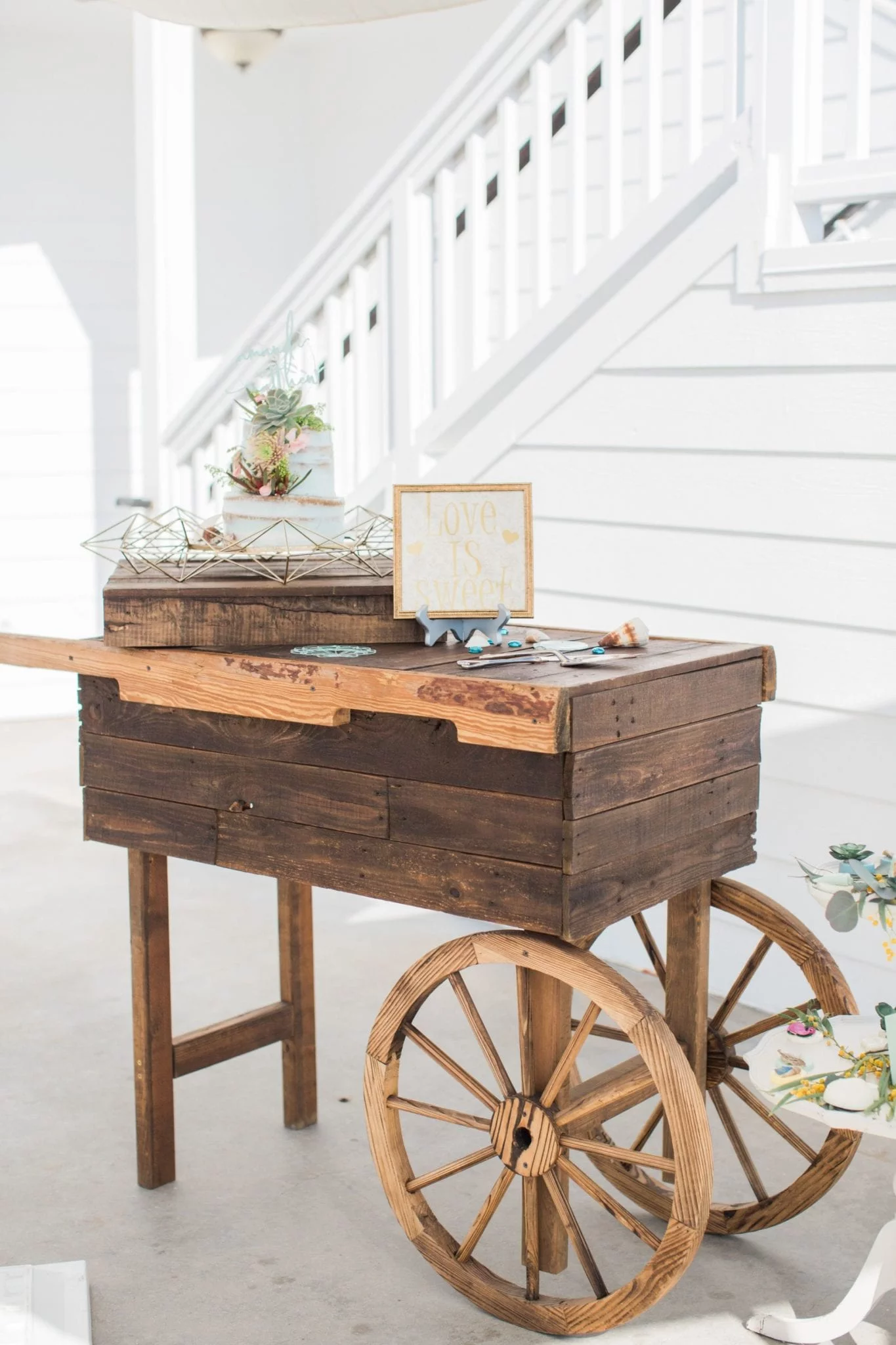 A rustic wooden cart adorned with a charming sign, ideal for weddings in Southern California.