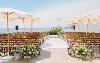 A beautiful beach wedding ceremony set up with chairs and umbrellas, perfect for unforgettable weddings in Southern California's Laguna Beach.